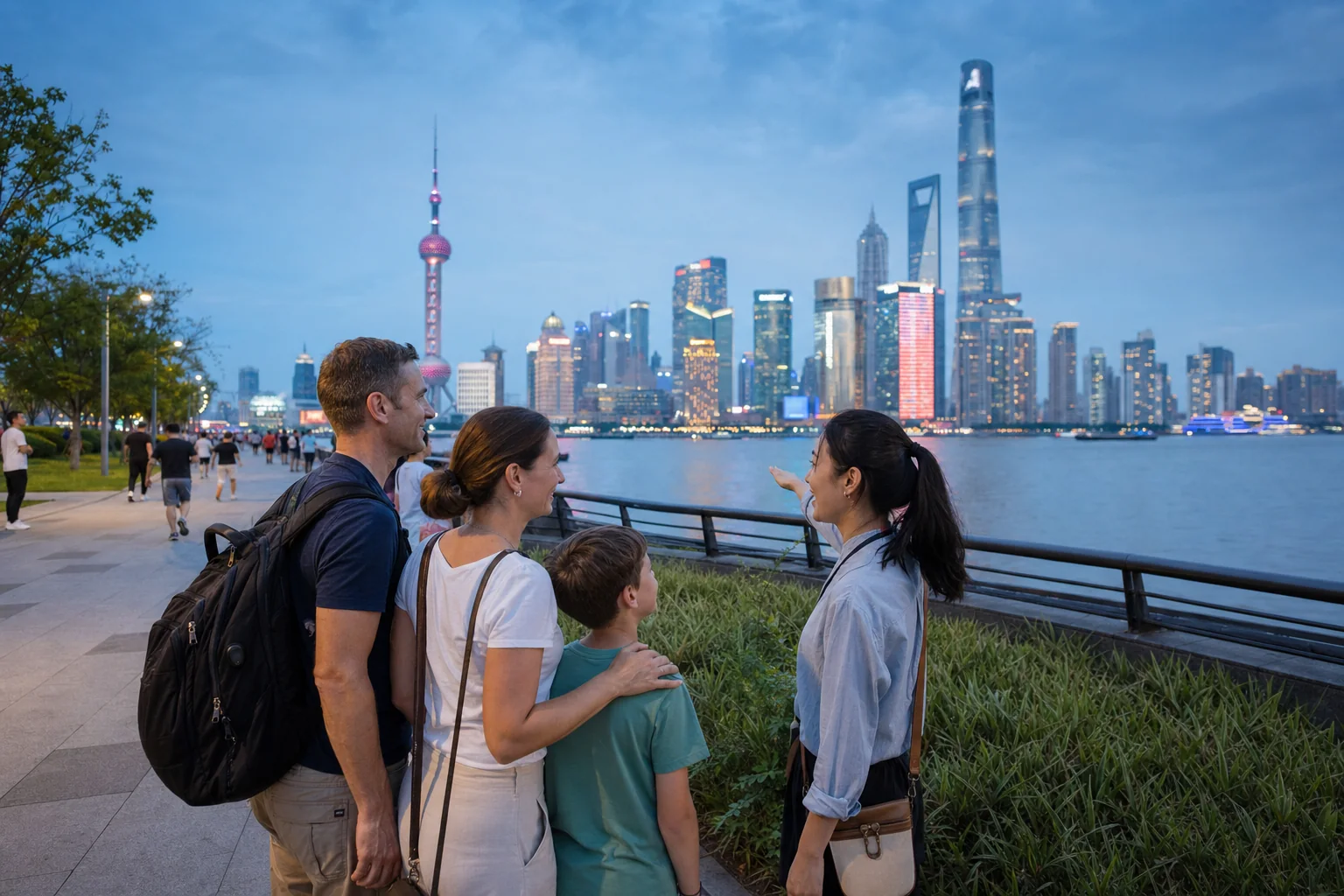 Family and local guide viewing the Pudong skyline from the North Bund riverside in Shanghai