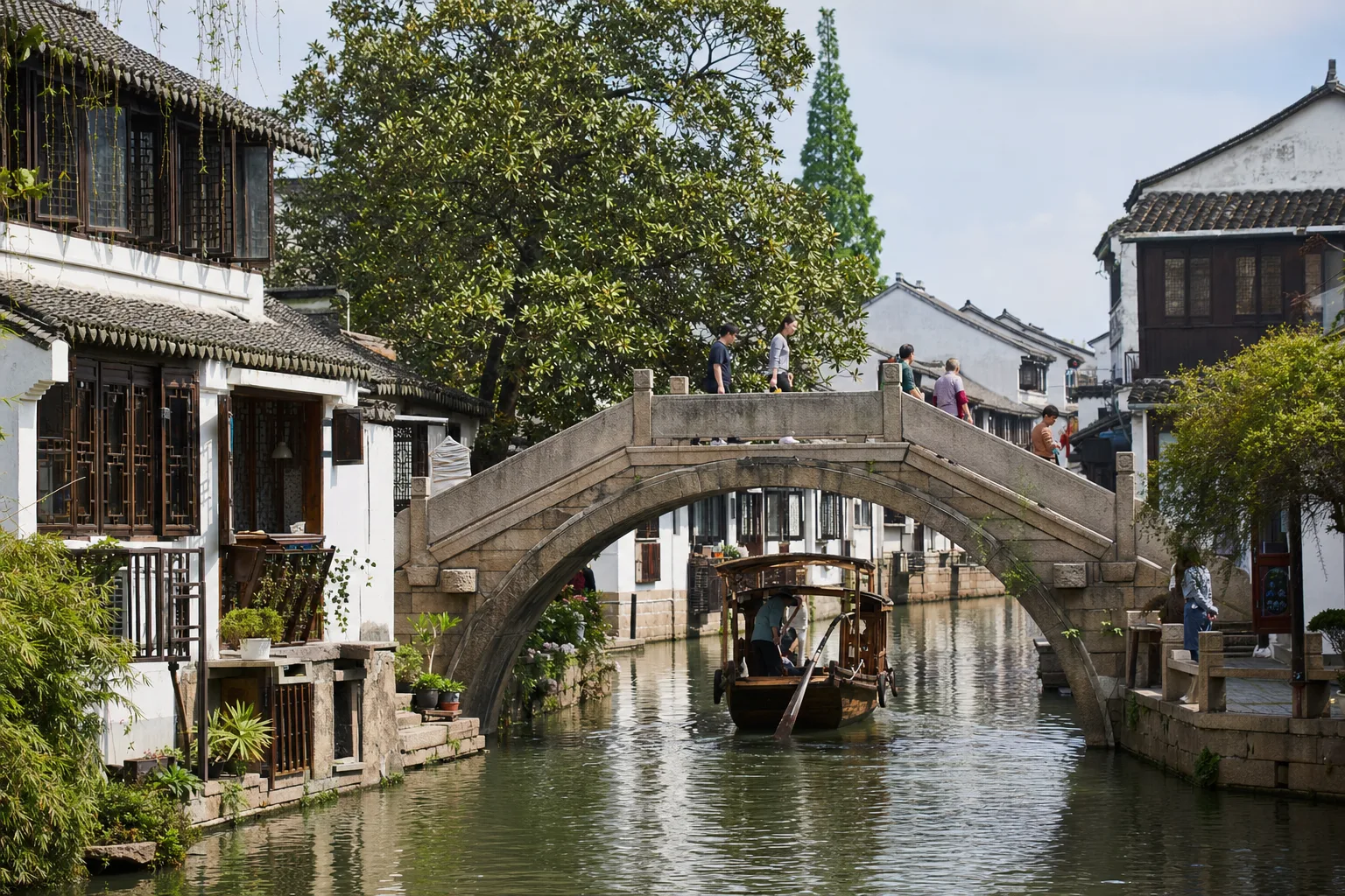 Stone bridge, canal boat and whitewashed houses in Zhujiajiao water town near central Shanghai