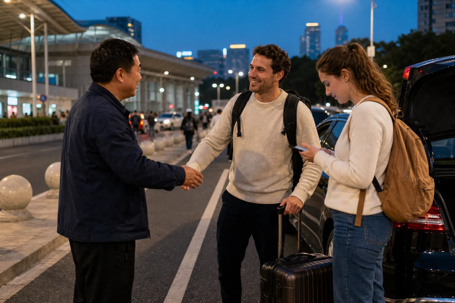 International travelers with luggage meeting a local driver outside a Shanghai railway-station arrival area at blue hour